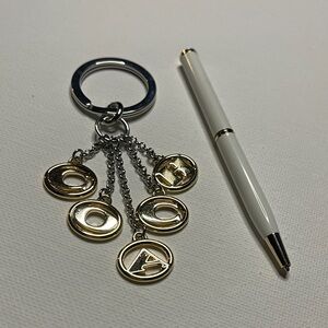 Coach Gold and Silver Keychain with a White Coach Pen
